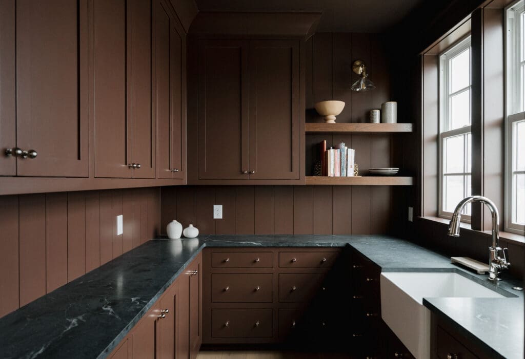 dark brown pantry with black marble counter tops designed by Abby Lucas Design