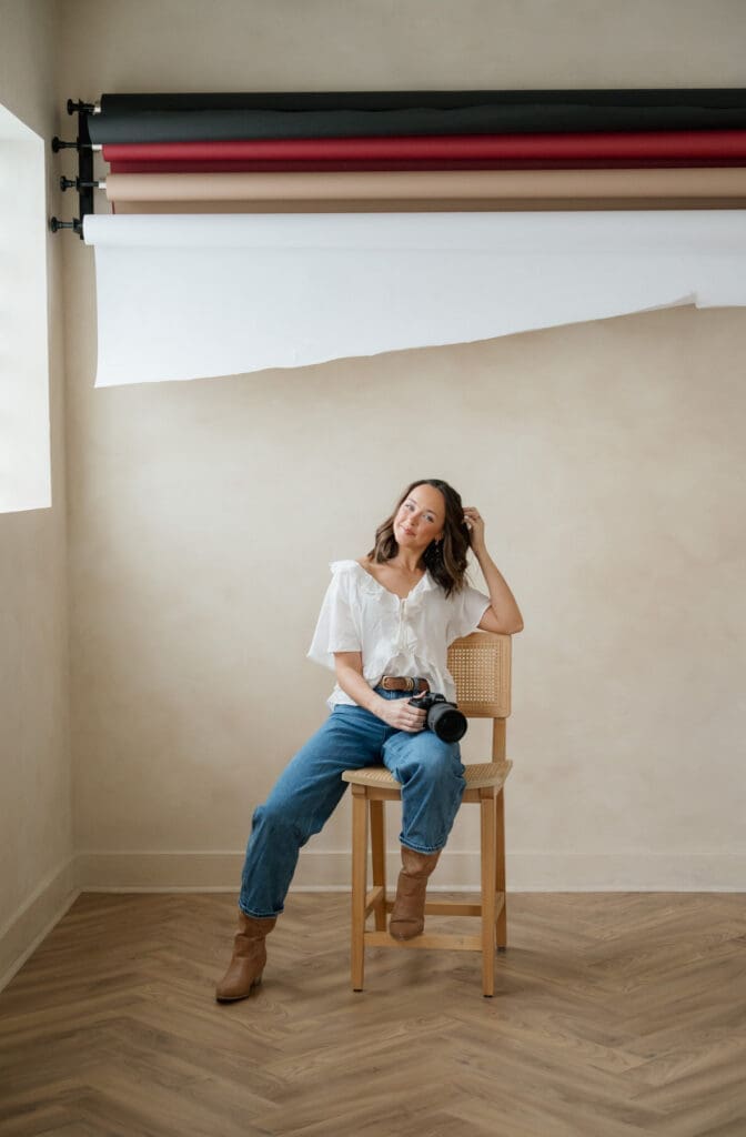 woman casually sitting on a chair during her brand photo session